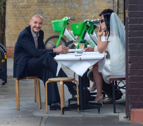 buturlosingit's tweet image. just married, cig & drink in hand, sat in front of lime bikes. the king and queen of east london. everything is romantic π