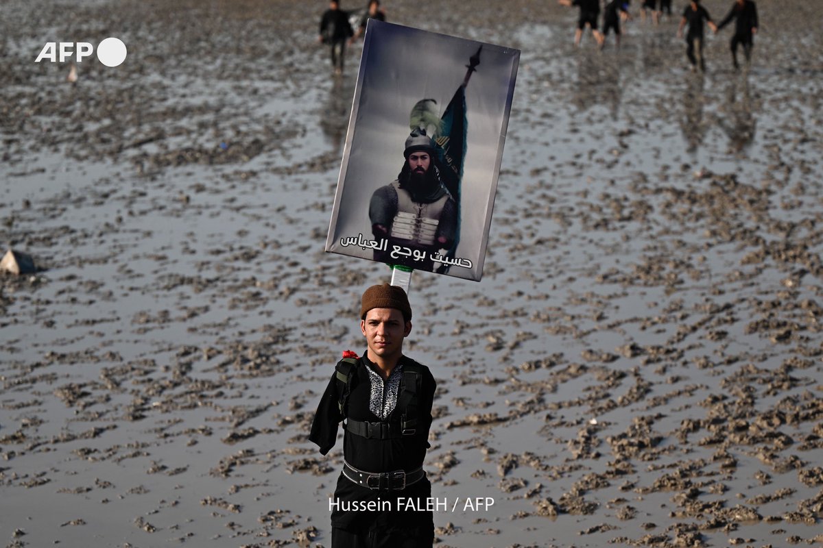 An aerial picture shows Shiite Muslims lifting flags while walking in Iraq's Basra province on July 19,2025,as they perform the yearly pilgrimage march, from the southern port city of al-Faw to the holy city of Karbala, ahead of the Arbaeen religious festival.
Hussein FALEH <a href="/AFP/">AFP News Agency</a>