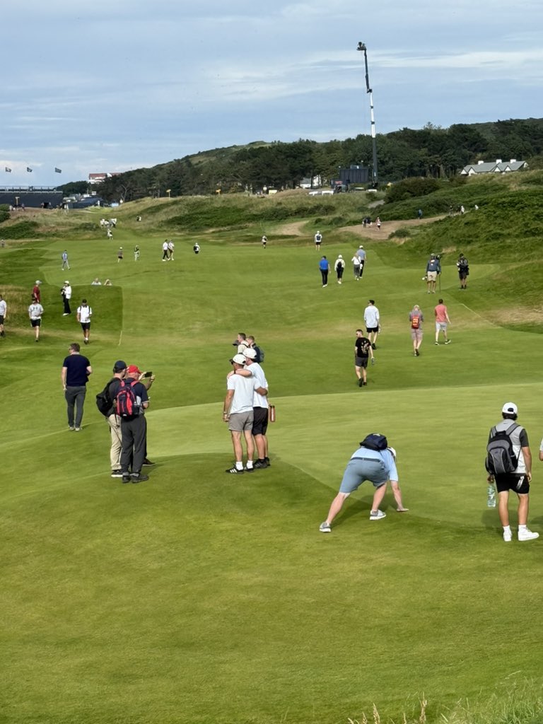 Only at The Open: There are fans just walking down the middle of fairways, tees, and greens taking pictures on the holes that the final group has passed through already.