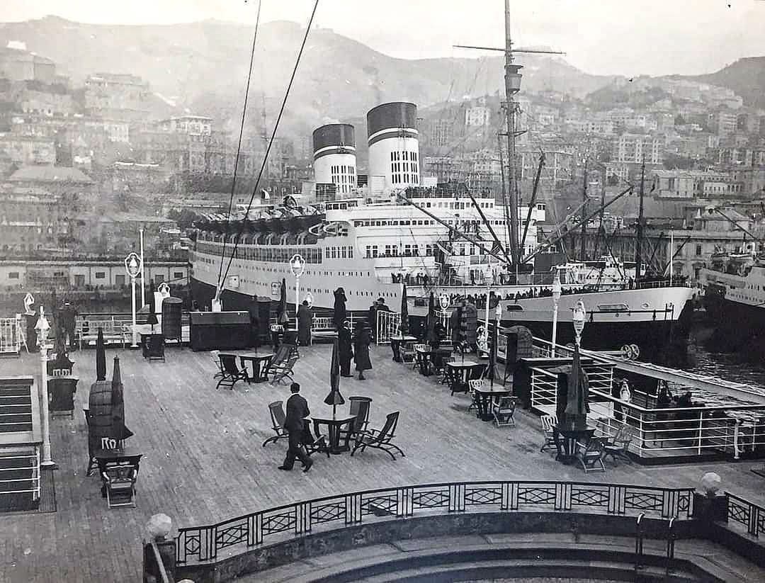 The SS Conte di Savoia is visible from the First Class pool area of the SS Rex in Genoa, Italy.
