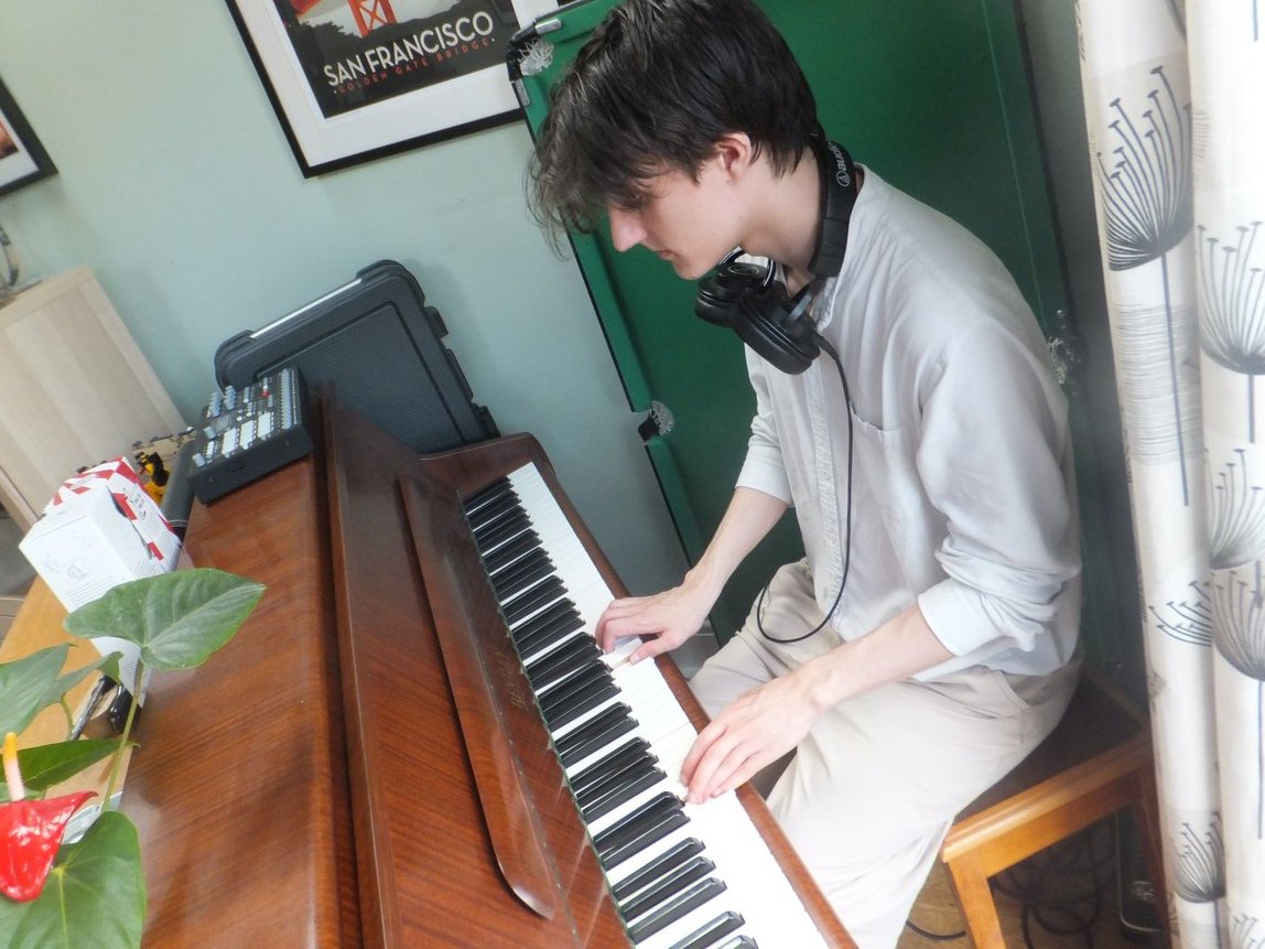 behrdz's tweet image. And here is a photo of me playing the piano acccompanied by an Elektron drum machine.