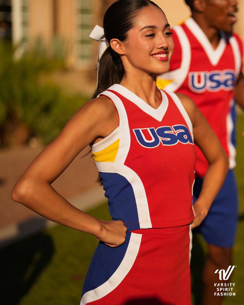 Classic red, white, and blue get a modern edge with pops of yellow highlighting the custom back logo. Designed to complement the Song Pom uniform, the look is pulled together with sleek blue side panels and crisp white striping for a unified finish. #VarsityStyle <a href="/usa/">USA</a>