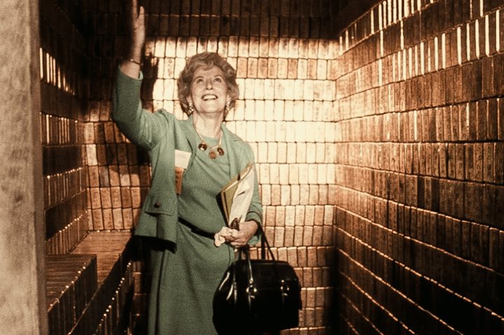 CyberPunkCortes's tweet image. Mary Books, Director of the US Mint, showing off the gold bullion in the Fort Knox Bullion Depository, 1974.