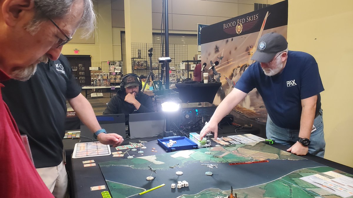 HMGS_Inc's tweet image. Doug Glover & the crew of Lead Pursuit were streaming games of Blood Red Skies-Beyond MiG Alley all weekend at #Historicon2025. Their presence added a great energy to the Exhibit Hall & we are grateful they joined us. Check out their YouTube to understand Doug's expression below!