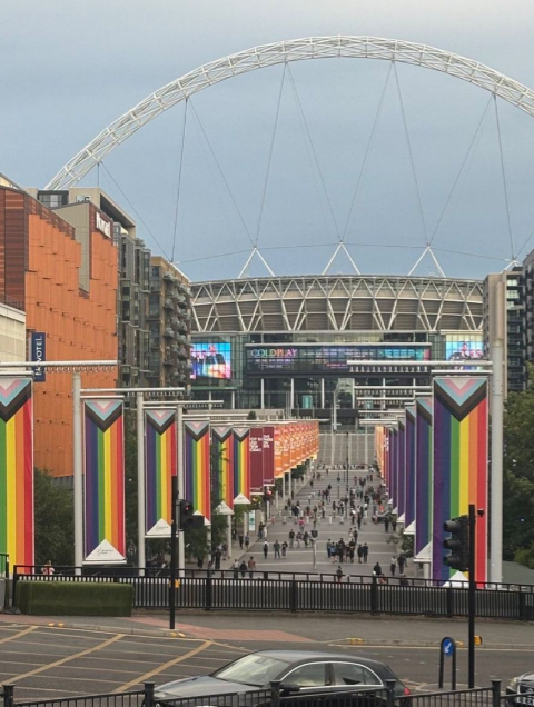 darrengrimes_'s tweet image. Wembley’s iconic arch—once a symbol of footballing glory and national pride—now flanked like it's auditioning to host a UN DEI conference.