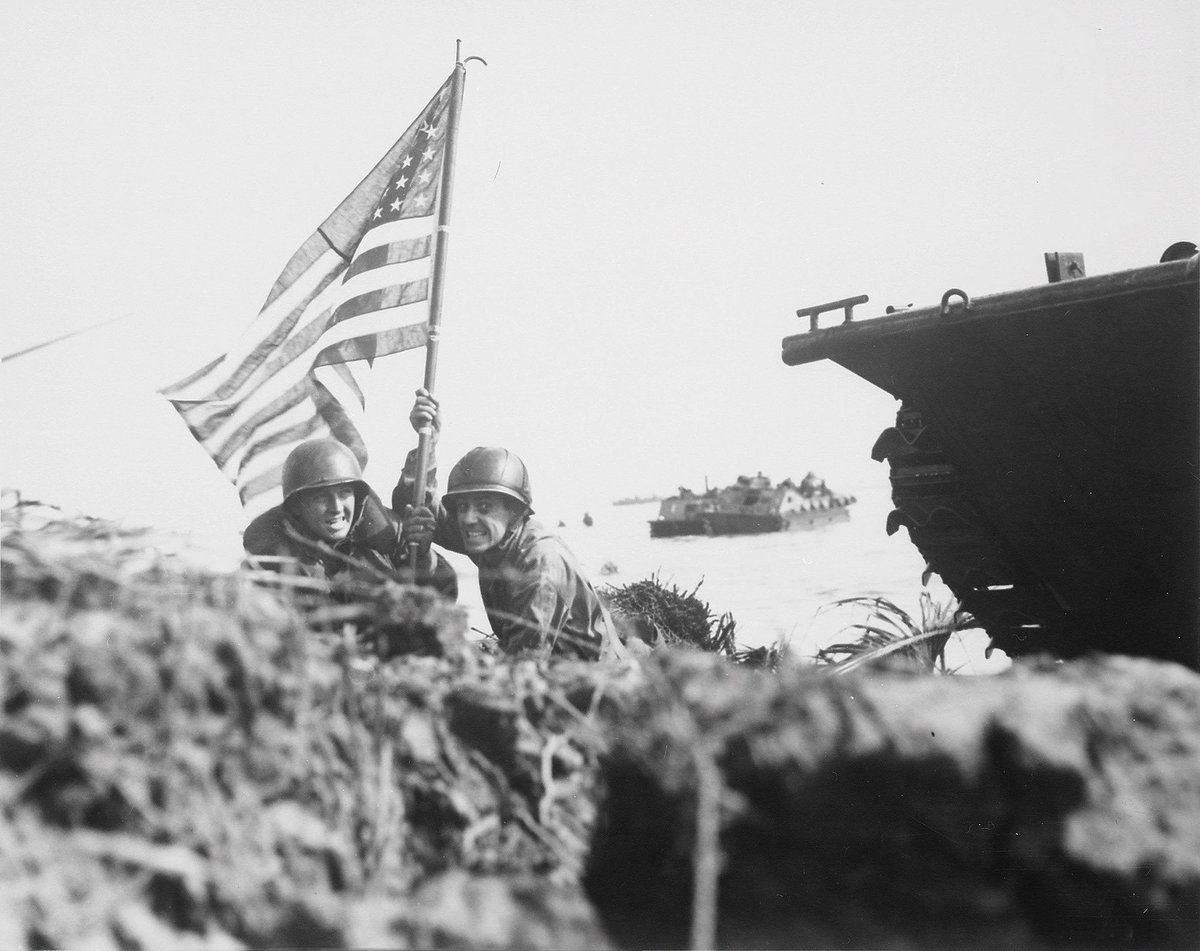 NavalInstitute's tweet image. #OTD in 1944, U.S. amphibious forces began the liberation of Guam. Eight minutes into the assault, two Marines used a boat hook as a mast to plant the first U.S. flag in the campaign to recapture the island from the Japanese.