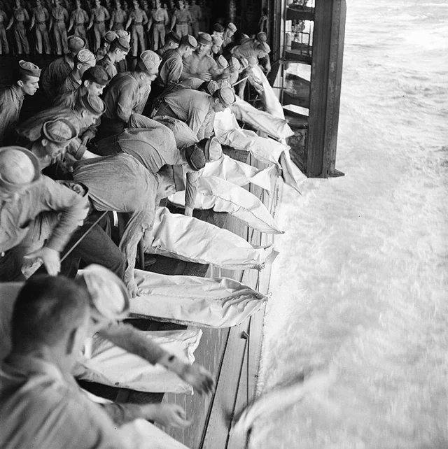 HistoricHub's tweet image. Sea burial for sailors killed on the USS Intrepid (CV-11) after a kamikaze attack off the Philippines on November 26, 1944.