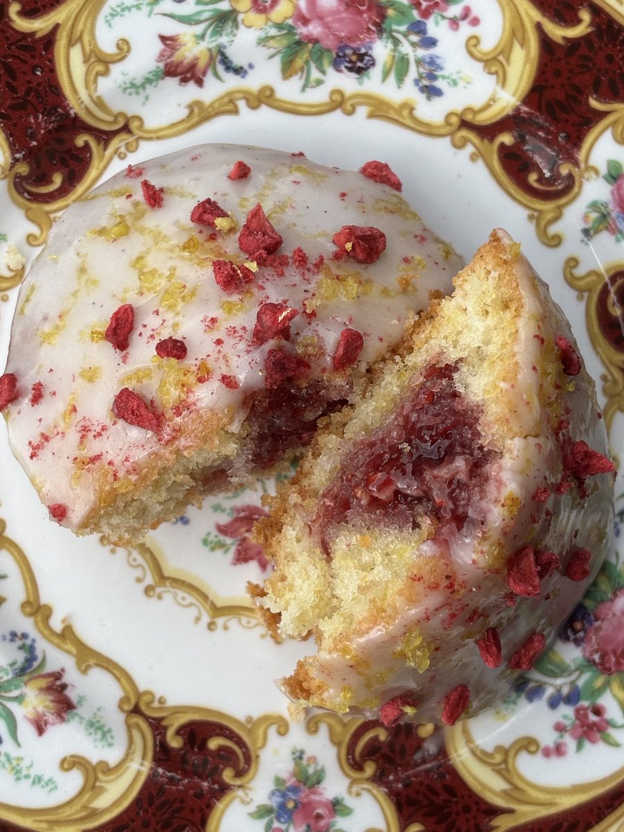 bakingenjoyer's tweet image. lemon madeleines filled with raspberry jam, topped with a lemon and vanilla bean glaze !!