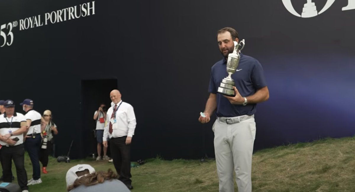 KylePorterNS's tweet image. Maybe the most golf dad moment of all time. The Claret Jug in one hand and a pacifier in the other. Frame it.