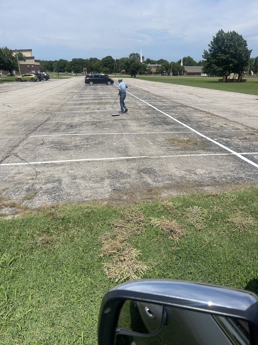 Hard working maintenance getting parking lots ready for students.