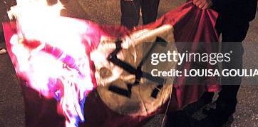 25YearsAgoLive's tweet image. Protestors from the Jewish Defense League burn Confederate and Nazi flags to protest an arson attempt against a Reno, Nevada synagogue.
The Anti-Defamation League (ADL) criticizes the move and says that it is not constructive to burn any kind of flag.
