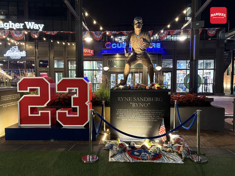 More flowers, an American flag, and a ’23’ grace Ryne Sandberg’s statue tonight.
