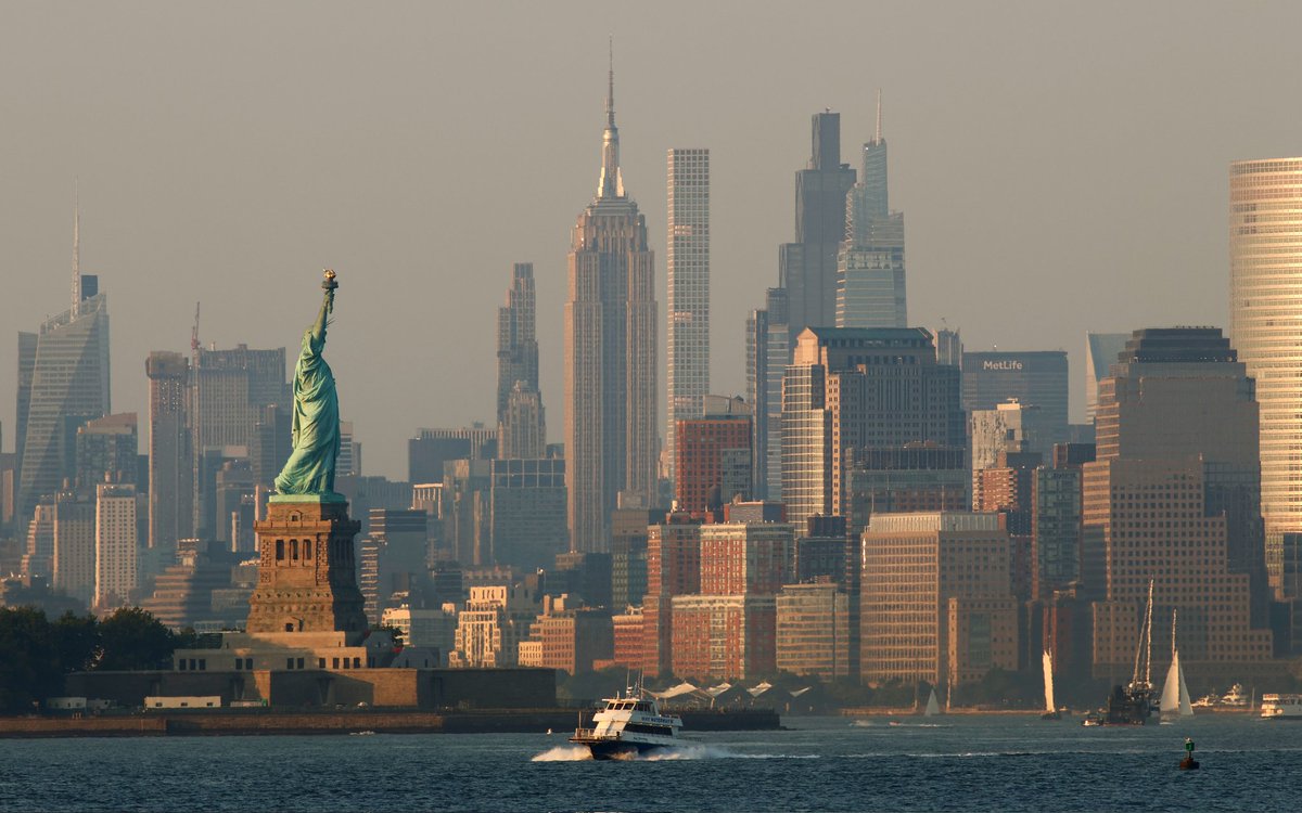 Sunset on the Statue of Liberty and Empire State Building in New York City, Monday evening #newyorkcity #nyc #newyork @empirestatebldg #statueofliberty