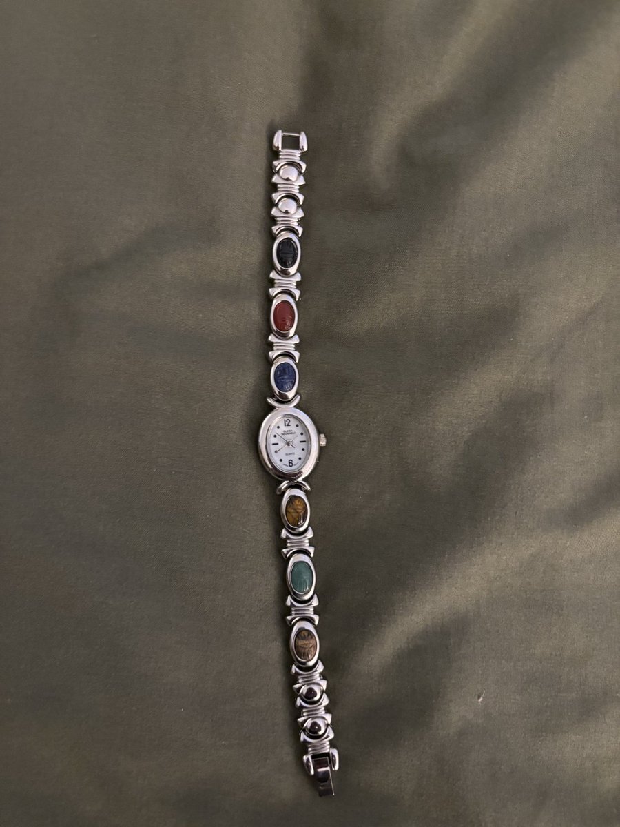katiopolis's tweet image. some of my favorite estate sale finds from last week: cool packers merch, vintage gloria vanderbilt watch, and house on the rock promo mag and space coffee table book from the 70s