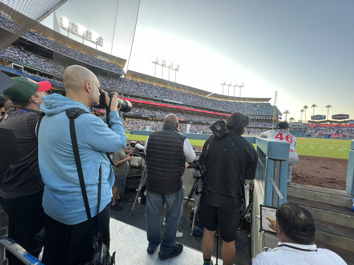 Somewhere through this crowd of photographers is Shohei Ohtani up to bat. 

And he just hit a 2-run homer.