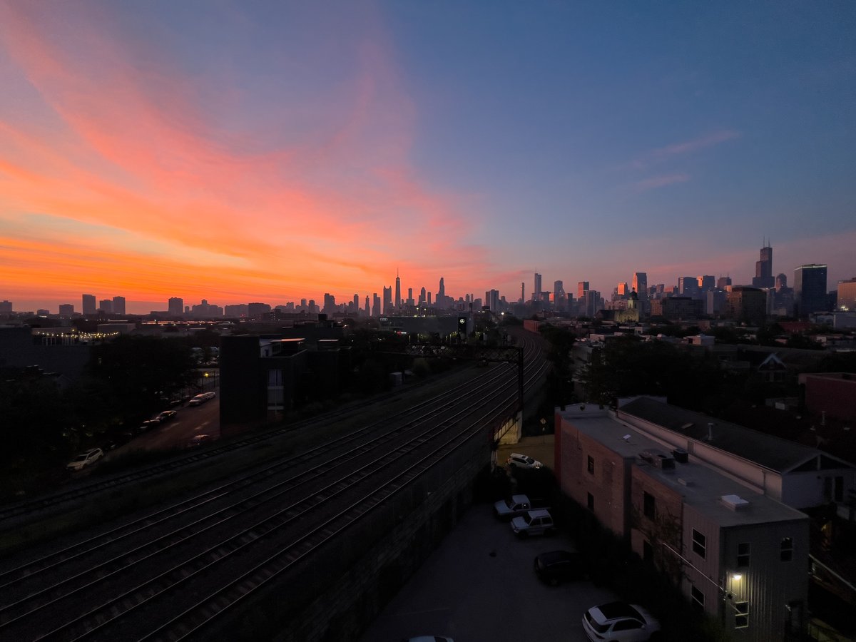 cshimala's tweet image. Woke up on the couch at 5:15am to this swoop of color over the Chicago skyline. Related, I had used my dog's bed as a pillow.