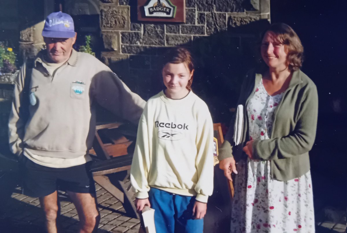 HiddenYorkshire's tweet image. Random photo outside a pub, wearing hand-me-downs which don't fit, holding a book...all-time awkward family photo
