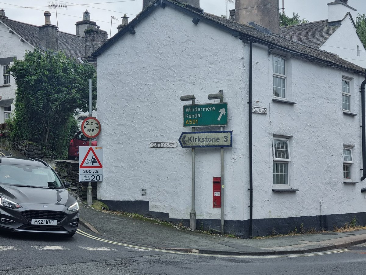 thelonningsguy's tweet image. Ambleside's iconic postbox (hideously blocked by signposts 😡) - and how it looked in the 1920s complete with the optimistic planting of a tree on the roundabout. #Cumbria