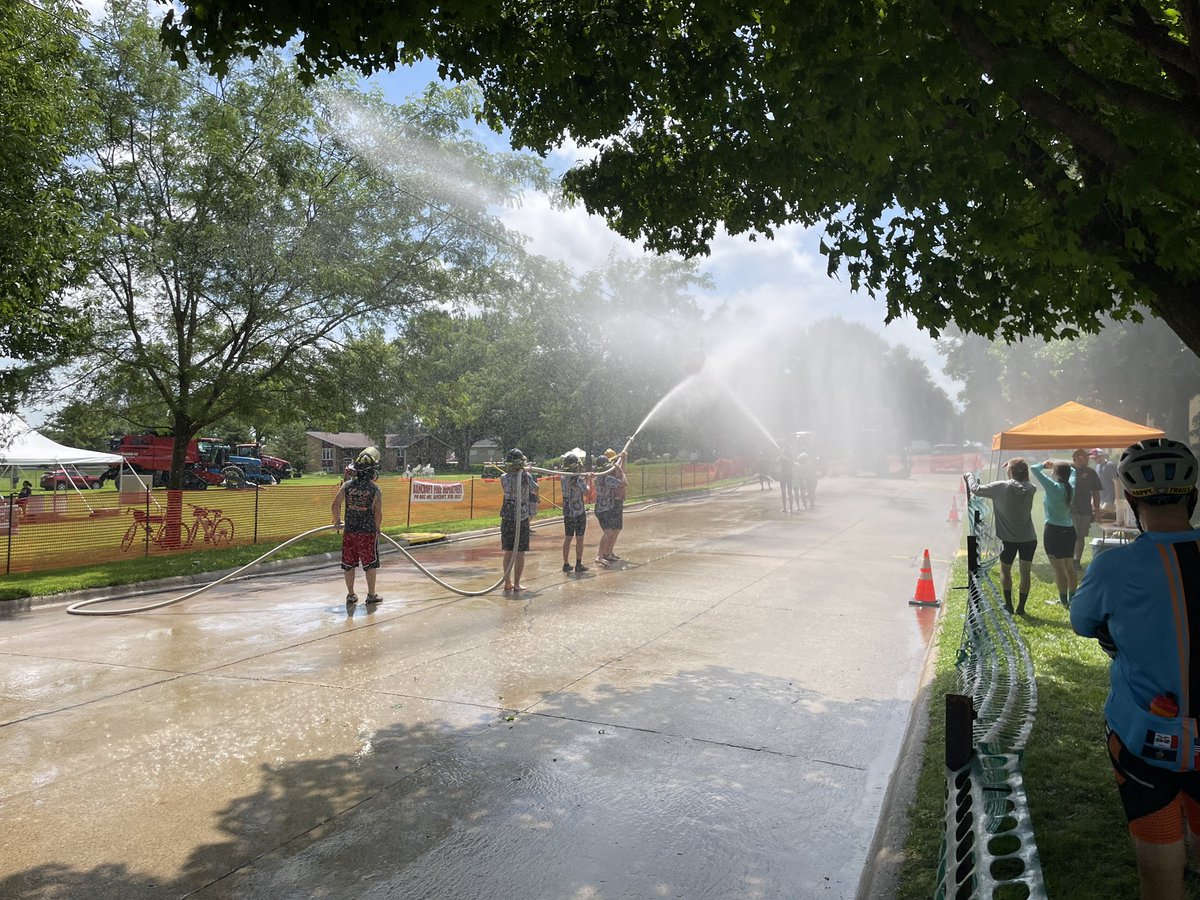 HorsleyScott's tweet image. Dueling cycle teams use fire hoses to try to push a beer keg along a clothesline