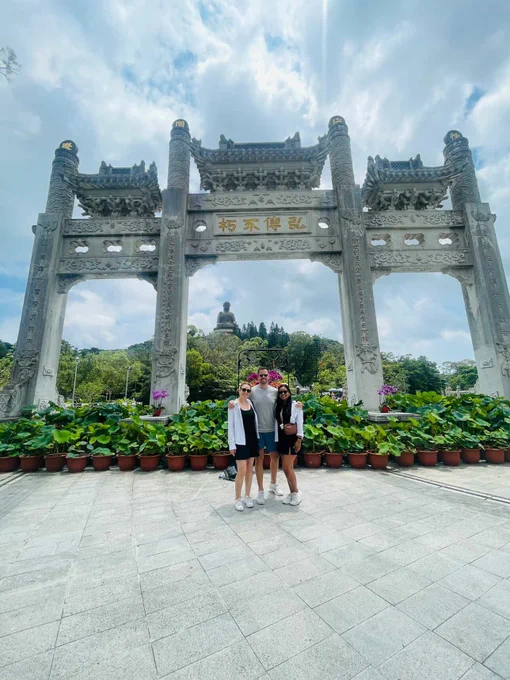 Group of Georgetown students in Hong Kong in front of monument