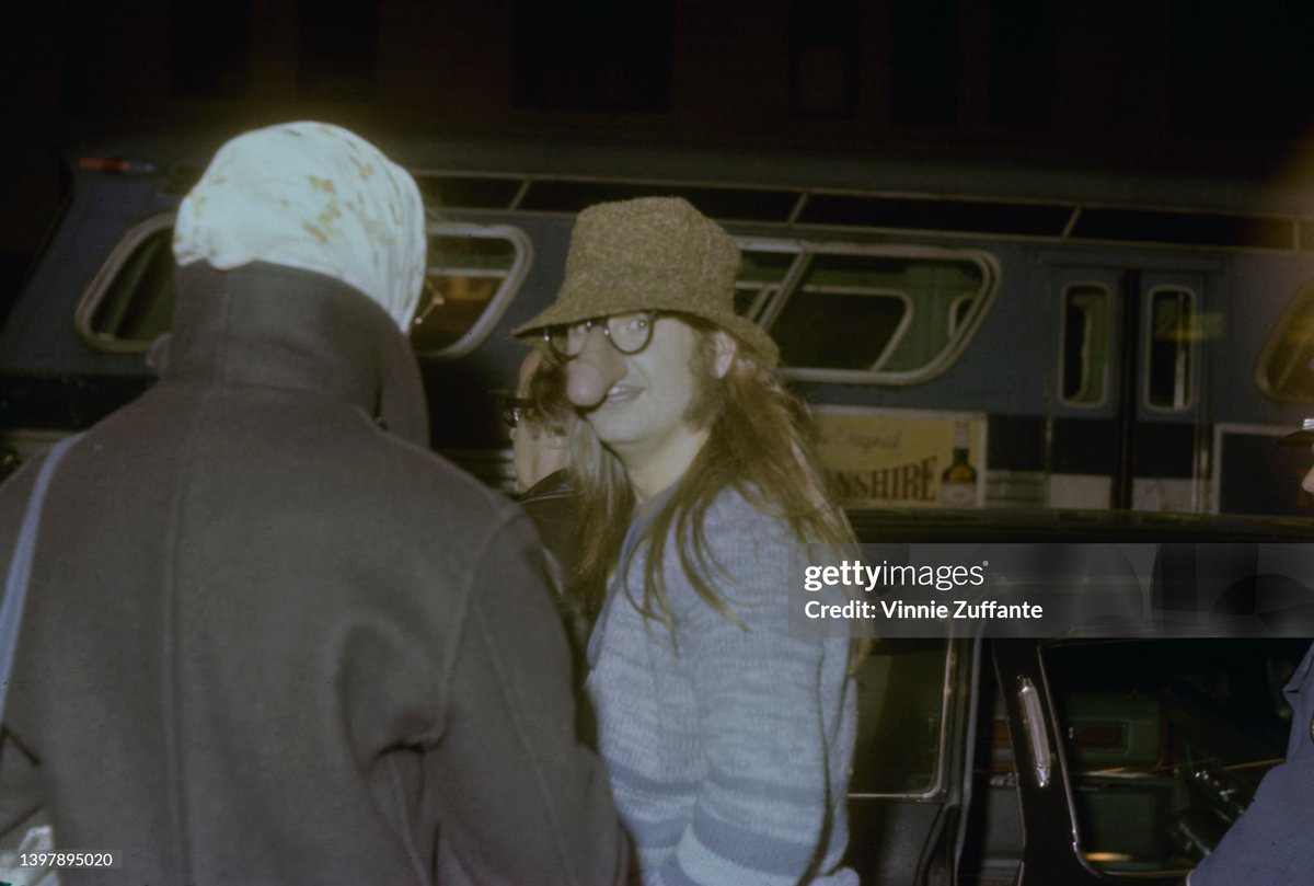 shitbritishpics's tweet image. British singer and songwriter Ozzy Osbourne, wearing a blue striped cardigan with a brown hat and a pair of 'nose glasses' which feature a penis over his nose, speaking with an person (1980)