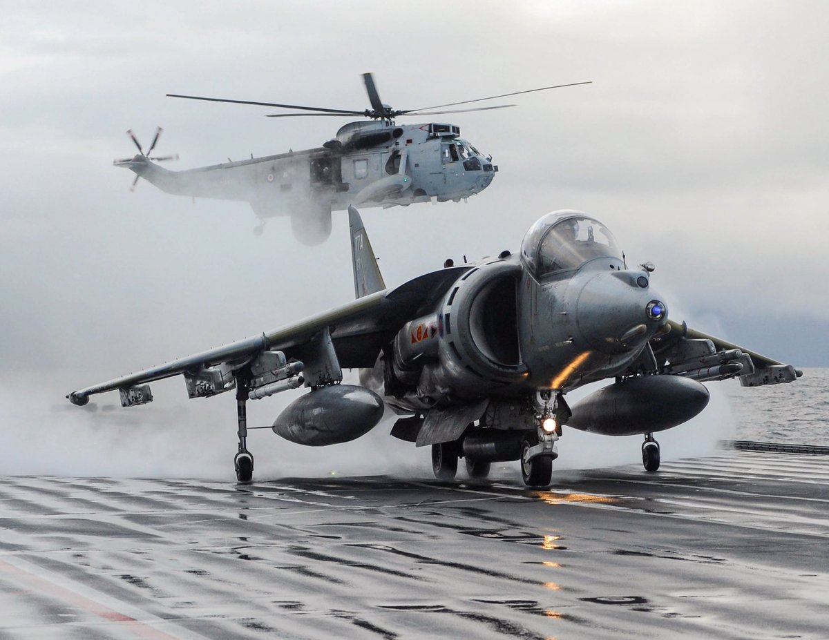 kadonkey's tweet image. An RAF GR9 Harrier takes off from HMS Ark Royal for the very last time, whilst a Sea King helicopter hovers in the background 24NOV10 (POA(Phot) Ray Jones)