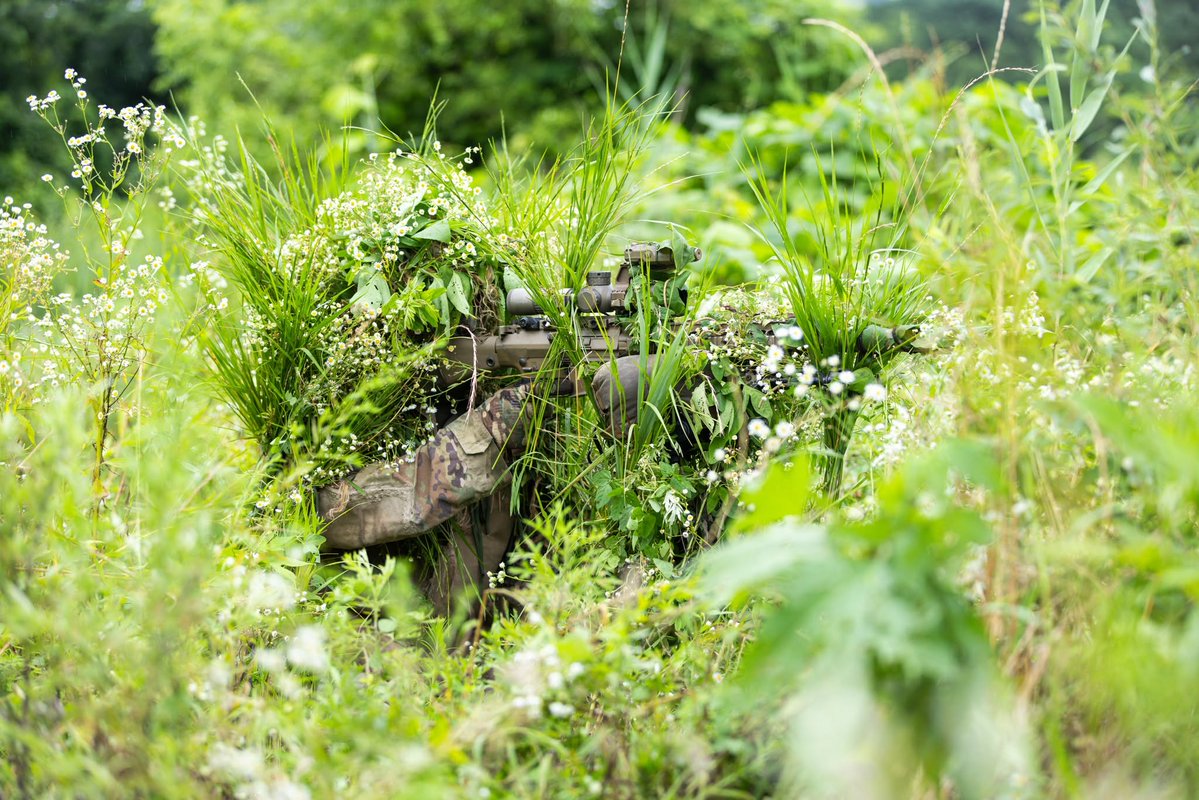 EighthArmyKorea's tweet image. Snipers from 23rd Infantry Rgt., 1st Stryker Bde Combat Team, 4ID, hone their fieldcraft during camouflage training, focusing on target indicators & the application of natural vegetation to both themselves & their equipment. Precision, patience, & the craft of remaining unseen🫣