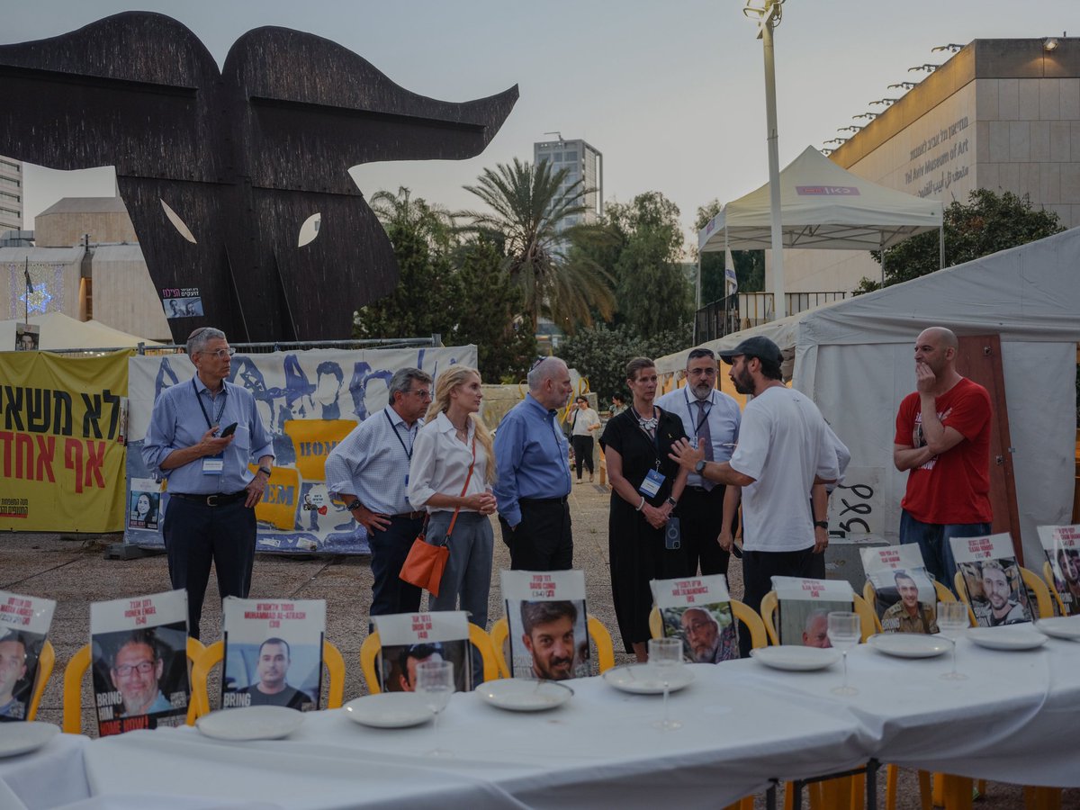 Conf_of_Pres's tweet image. At Hostage Square in Tel Aviv, our Solidarity Mission stood face to face with courage and pain. We met with freed hostages and the families of those still held by Hamas. Each empty seat and photograph is a call to conscience. We will not rest. #BringThemHomeNow 🎗