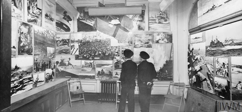 Normandy661944's tweet image. A display of work by Naval photographers in the waiting room at the Admiralty, May 1944. In the centre is the battle ensign of HMS Starling, commanded by Capt F.J. Walker, the most successful anti-submarine warfare vessel of the Royal Navy.
IWM (A 23643), Lt McNeill RN
