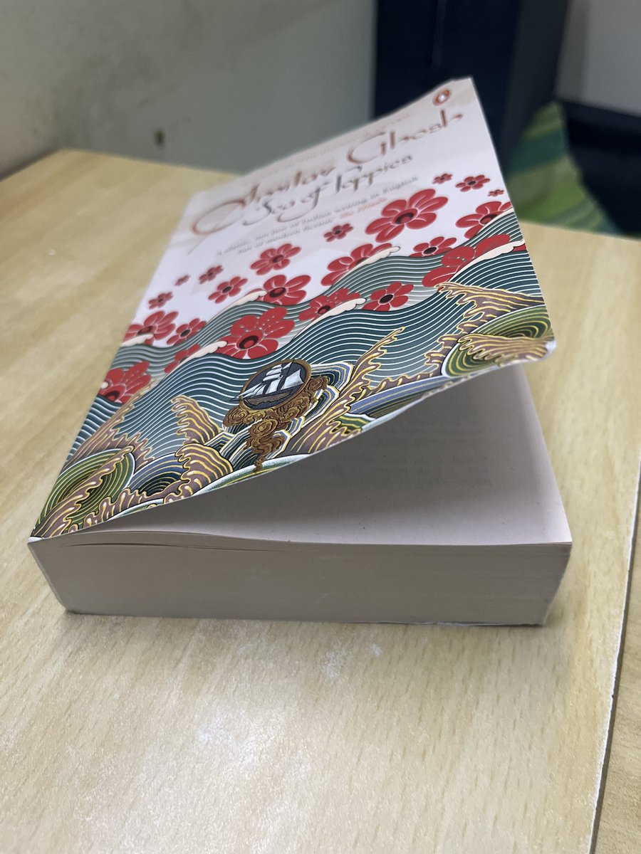 ideasmithy's tweet image. What is this garbage quality book cover for Amitav Ghosh’s ‘Sea of Poppies’? What makes it worse is the book is really good and the design is lovely. Too scared to breathe while reading as it’s warping and dog-earring on impact. Even the crochet sleeve isn’t helping. #Books