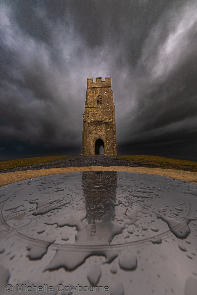Raindrops on the compass stone on Glastonbury Tor.