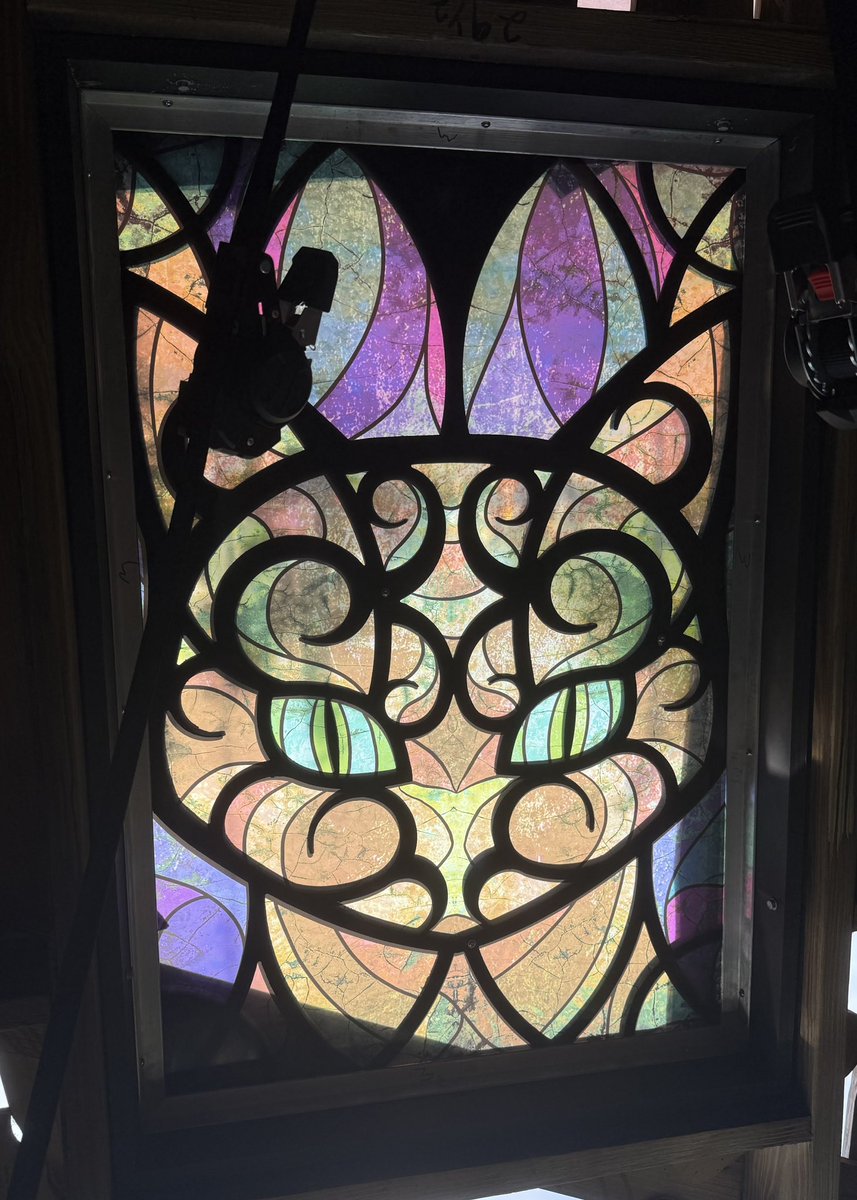 SpeculationMatt's tweet image. Look what happens when you view the stained glass design upside down! It looks like we have some feline inspiration. #HHN34 #HHN