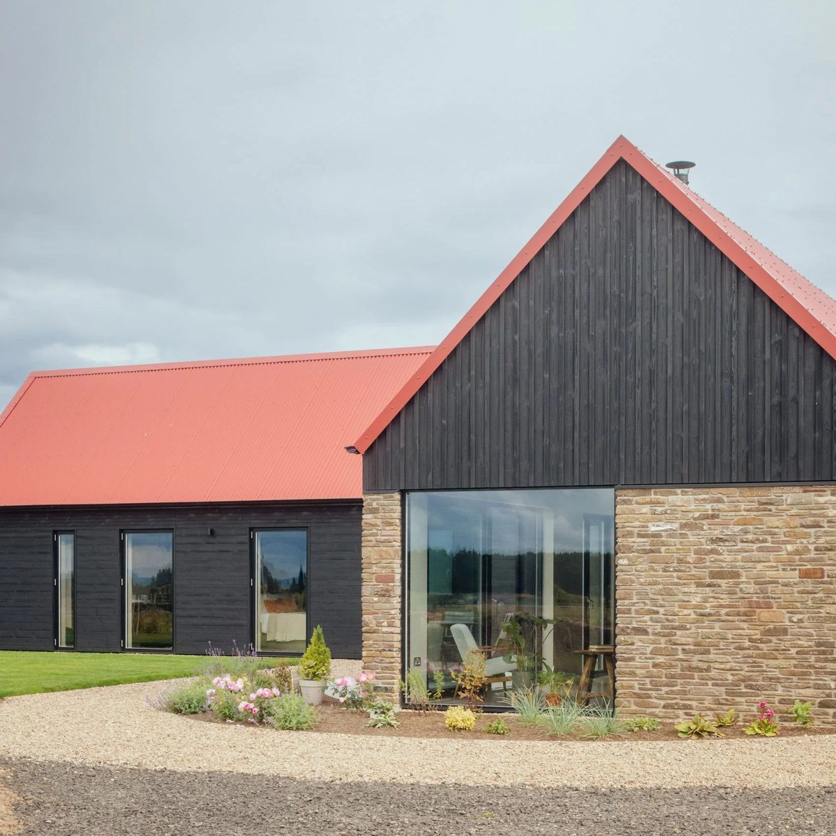 dezeen's tweet image. Five unassuming houses crowned with bold red metal roofs: dezeen.com/2025/07/20/red…