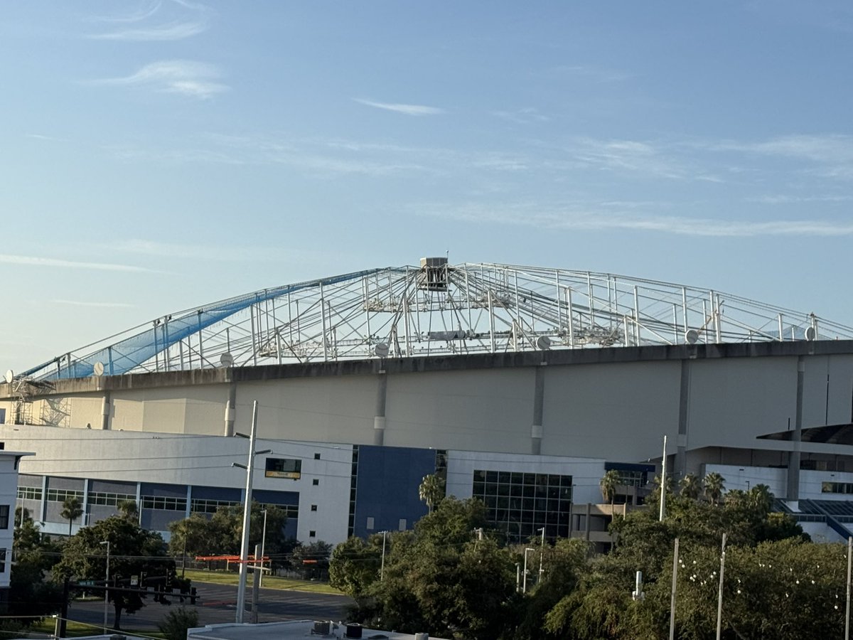 Ry_Bass's tweet image. A look at the blue netting being installed on the Tropicana Field roof, which serves as a base for the new roof build-out, expected to be completed by December. After that, turf installation and interior repairs begin. It’s a race to April for the 2026 #Rays home opener!