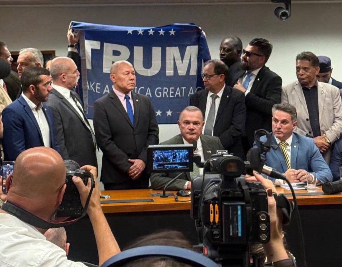 tuliogadelha's tweet image. Essa cena vai ficar na história como uma das mais vergonhosas do Congresso Nacional. Deputados eleitos por brasileiros, para trabalhar pelo Brasil, erguem com orgulho a bandeira de Trump, que simplesmente atacou nossa indústria e criou bloqueios contra a América Latina. Um nível…