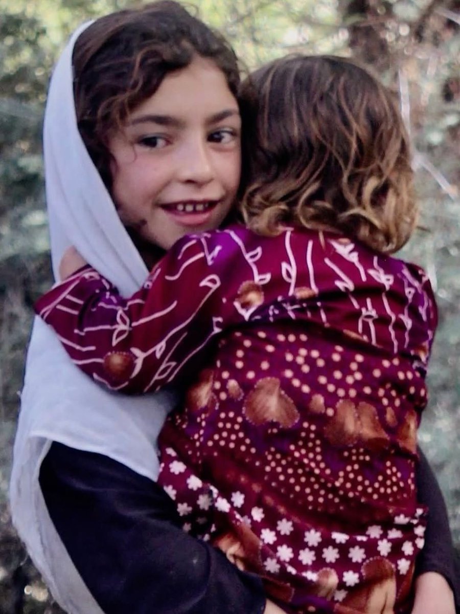 RoyGrinwis's tweet image. She holds her sister close and tight,
a shield of love, a flame of light.
No crown, no law, no tyrant’s hand
can break the bond where they now stand.
Her smile is more than simple joy
it’s courage shaped in one small girl.
Though barred from school, from books, from choice,
she…