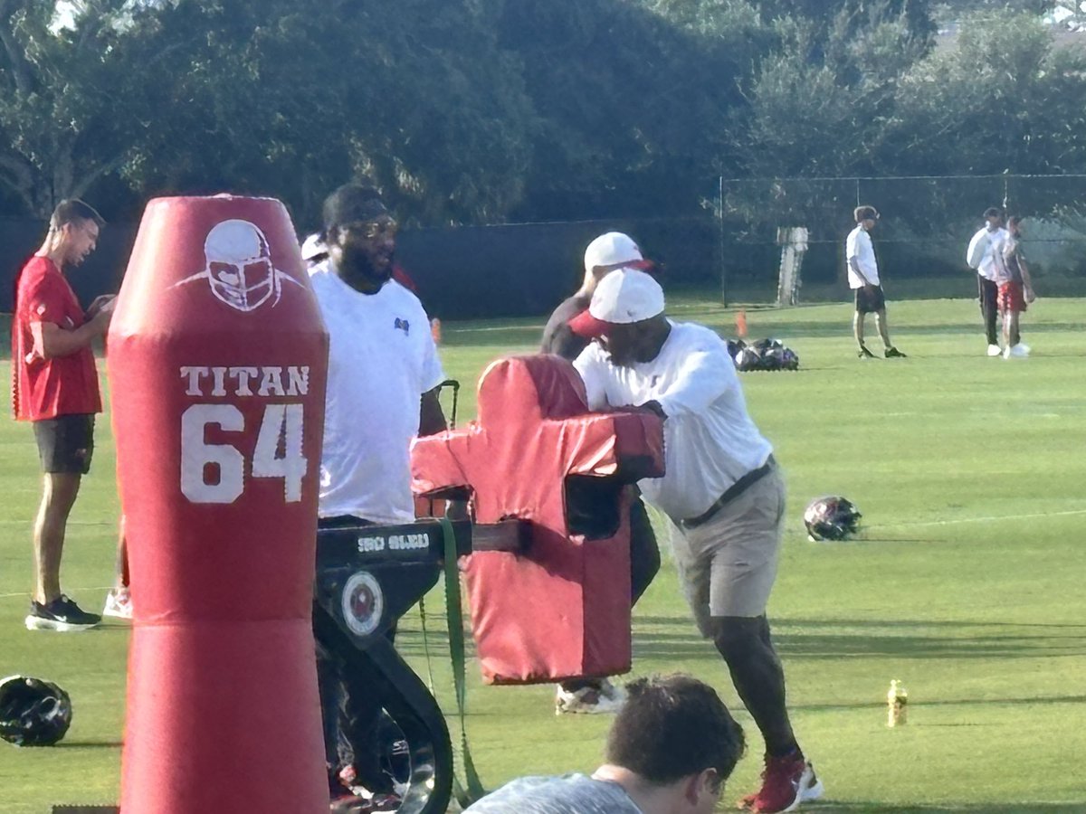 gregauman's tweet image. New Bucs defensive line coach Charlie Strong talking with Robert Ayers, who will be a coaching fellow in training camp and preseason.