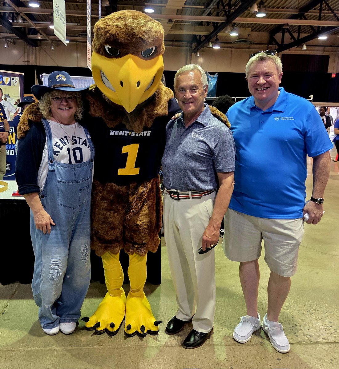 OhioHigherEd's tweet image. Chancellor Duffey and @LtGovJimTressel pose with @KentState's mascot, Flash, and the university's Provost, @MelodyKSU, during opening day of the @OhioStateFair.