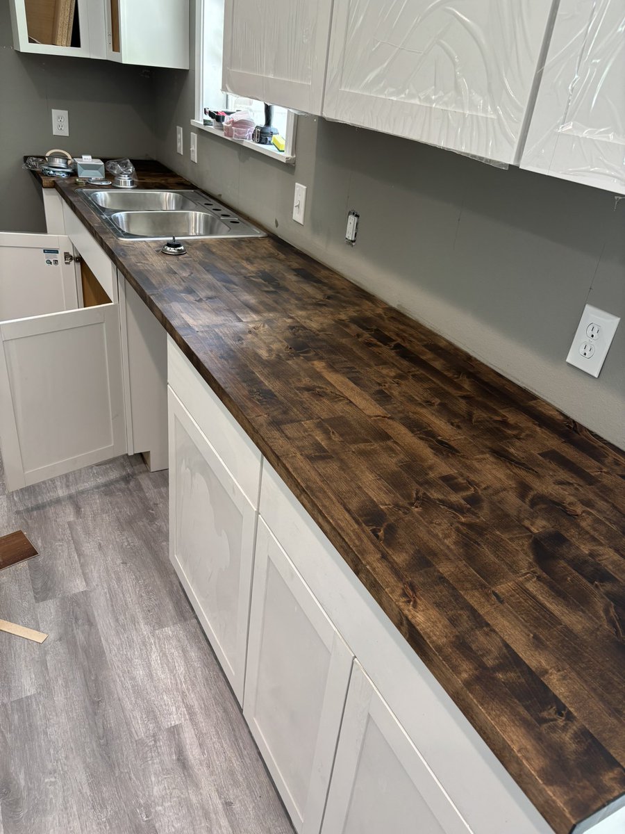 P202641716's tweet image. I installed these cabinets and butcher block countertop today, I stained it dark to complement the other light colors, got the sink cut out and dropped in as well. Gonna do a small white backsplash as well. A little small low budget insurance job, but looking nice!