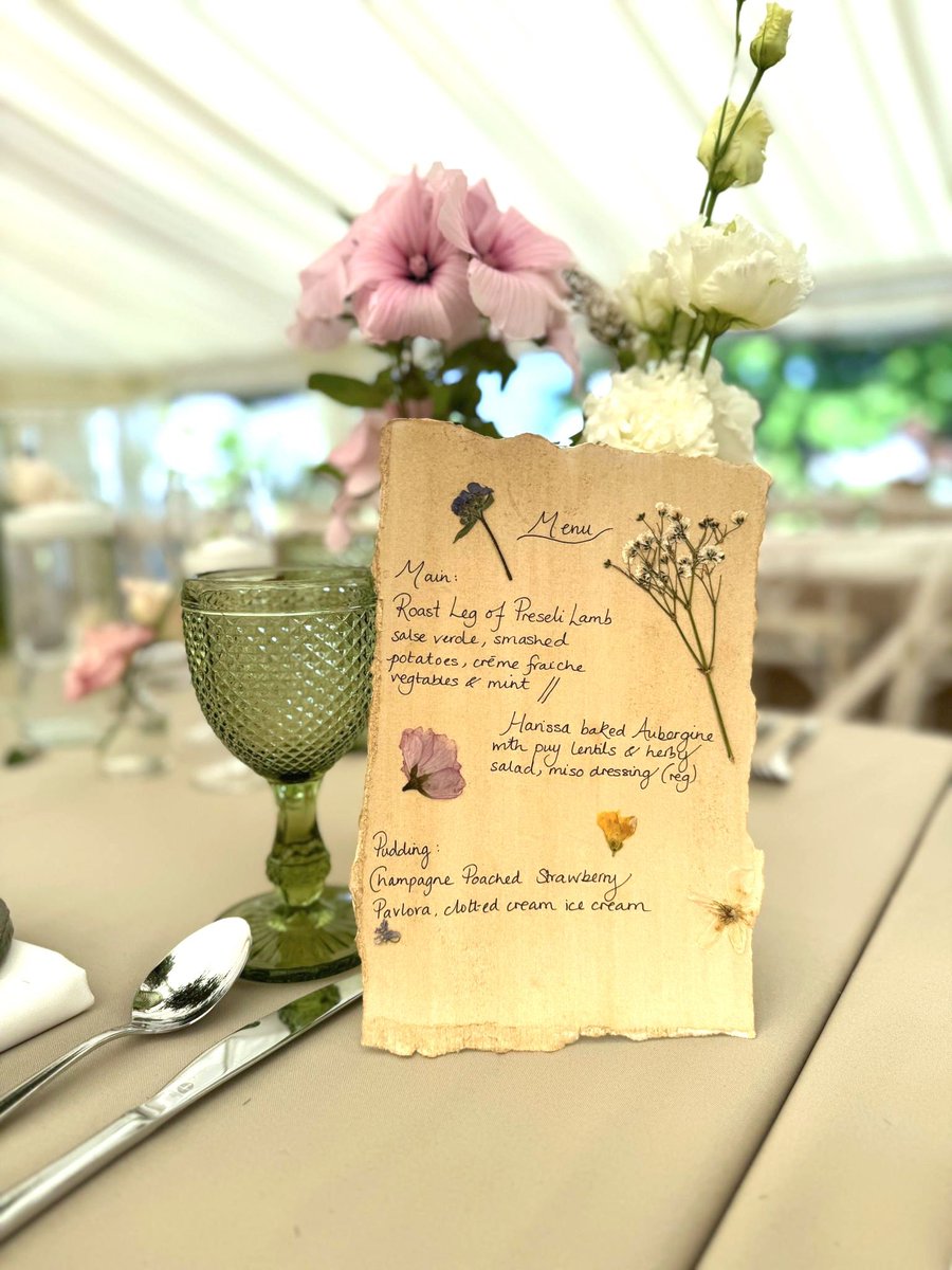 We love the personal touches—this handwritten menu with pressed flowers is stunning, and the dishes sound perfect!! 😉

#WeddingUnderCanvas #PembrokeshireWeddings #OutdoorWedding #LoveUnderTheStars #WeddingVibes #RusticWedding #HandMadeWedding