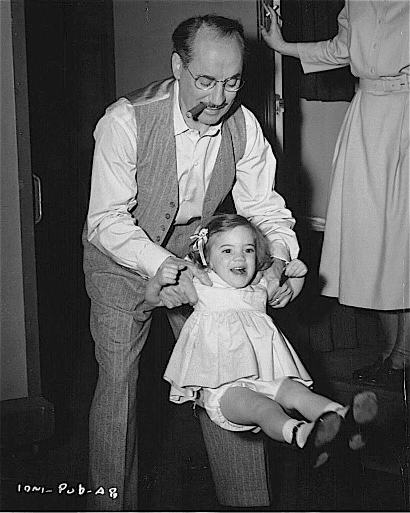 StoliarSteve's tweet image. During a break in the filming of &quot;Double Dynamite&quot; at RKO in late 1948, doting dad Groucho swings toddler Melinda, while mama Kay enjoys a cigarette. Due to studio owner Howard Hughes&apos; eccentricity, the film wasn&apos;t released until December of 1951.