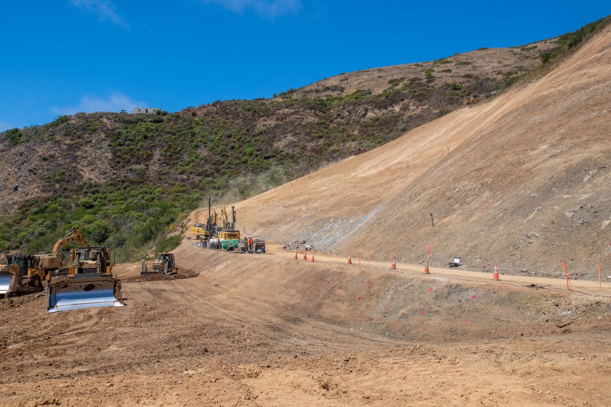CaltransD5's tweet image. Crews at work 7 days a week and extended hours at Regent’s Slide. Full-scale excavation resumed mid-July utilizing both conventional and remote-controlled equipment. Crews continue to install shear dowels in the cut slope to provide immediate and long-term slope reinforcement.