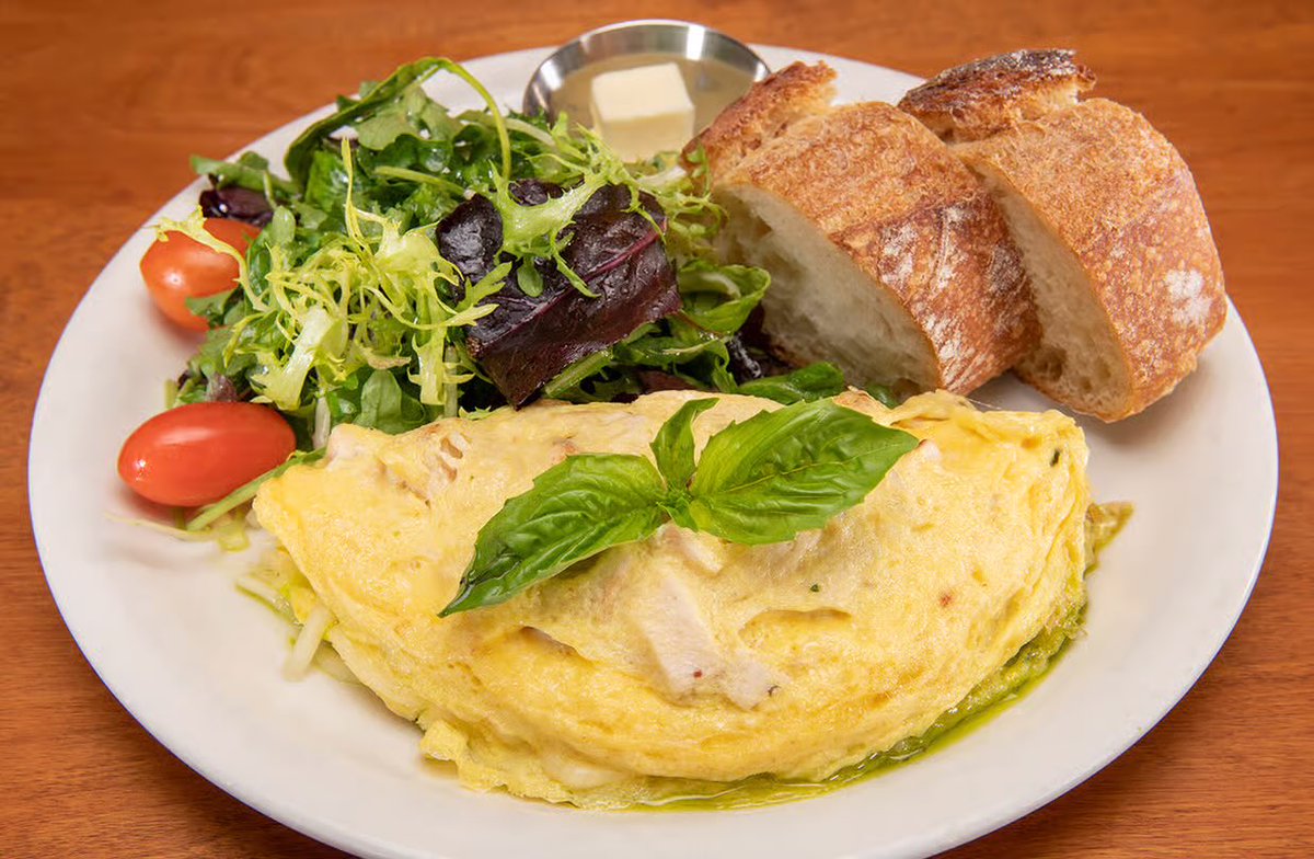 Fuel your morning with our protein-packed Chicken Pesto Omelet! Three eggs loaded with grilled chicken, savory pesto, melted mozzarella, &amp; tangy goat cheese. Served with a farm fresh mixed greens salad, it’s a flavorful, energizing start to power you through your day. #UrthCaffe