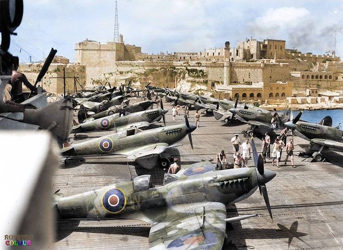 25 July 1944. Supermarine Seafire L.III of RNAS 808 Squadron on the deck of HMS Khedive entering the Grand Harbour of Valletta in Malta.