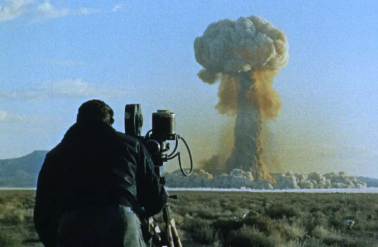 AtomicMuseum's tweet image. An airman films Shot HOOD, a 74-kiloton detonation during Operation Plumbbob at the Nevada Test Site in 1957. It remains the largest atmospheric nuclear test conducted in the continental U.S..