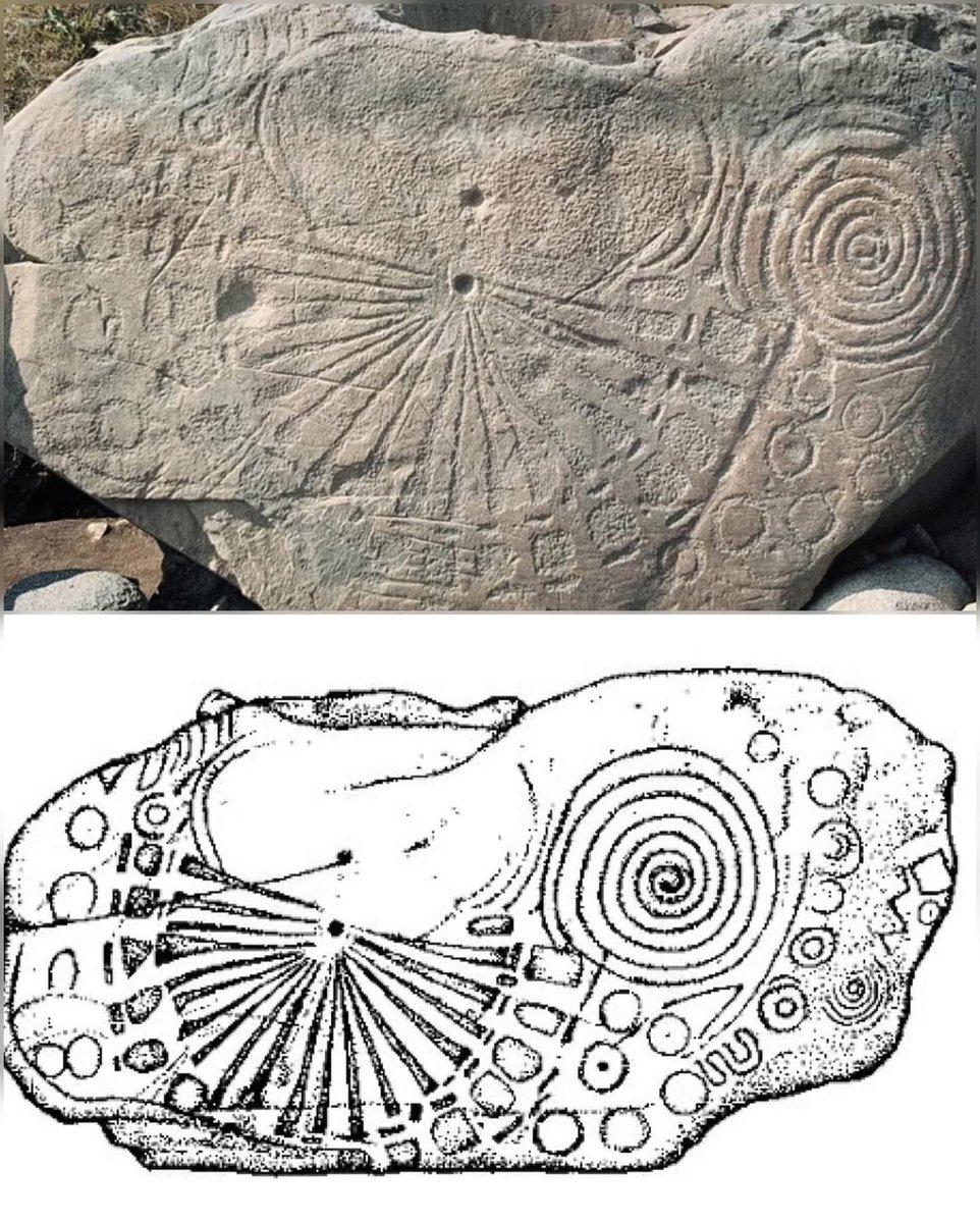 Kerbstone 15, a 5,000-year-old Neolithic artifact at the Knowth passage tomb in Ireland’s Boyne Valley, is carved with intricate designs including a central cupmark with 20 radiating lines, spirals, and U-shaped motifs. One of 124 kerbstones surrounding the site’s main mound, it