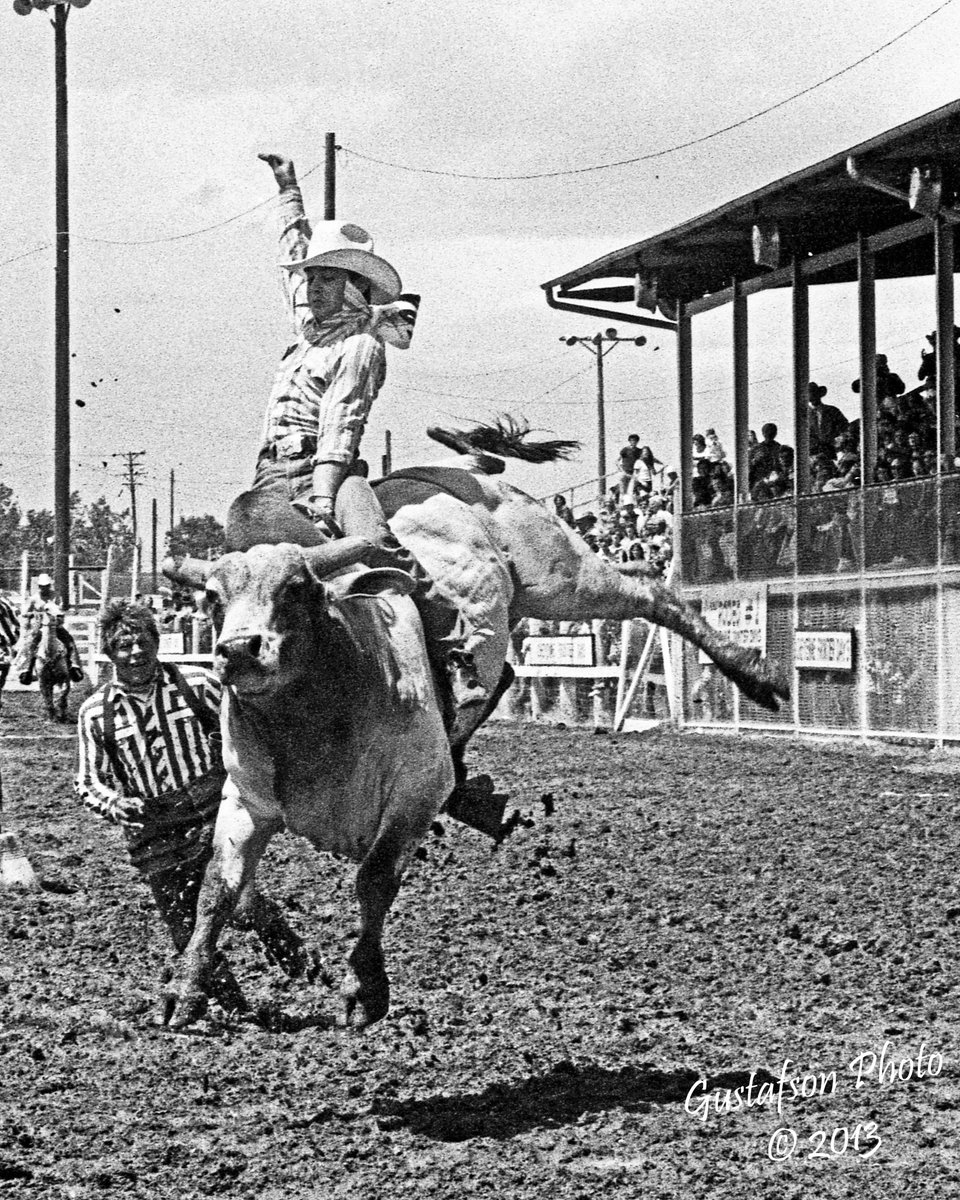 Mike Bandy - Class of 2025 Inductee - The Bull Riding Hall of Fame 
This great shot shows Mike on a bull named Jim at the 1973 Cheyenne Frontier Days. Also, Class of 2015 Inductee, Wick Peth, moving in. Photo from the Hall of Fame collection of 2019 Inductee, Jerry Gustafson.