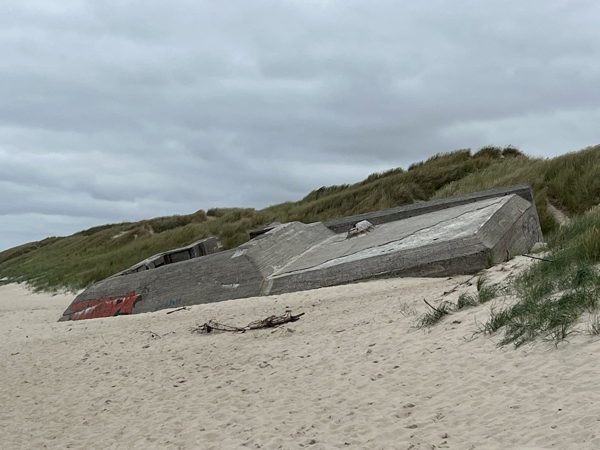 McC3Kat's tweet image. The thing I love most about Denmark is the 600+ km of mostly empty beaches. The second image is of a WW2 German bunker on the beach. It’s slowly sinking into the sand.