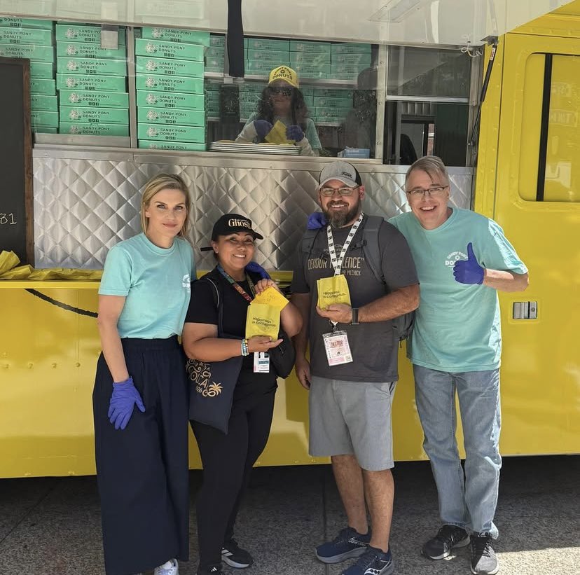 rheangelseehorn's tweet image. Rhea and Vince pose for photos with fans in front of the doughnut truck promoting #Pluribus
