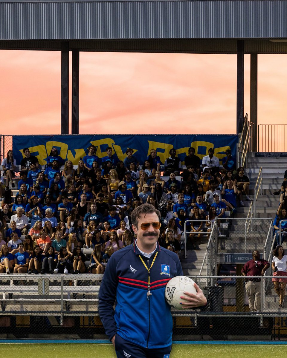 Ted Lasso, a tv character played by Jason Sudeikis, is photoshopped into a photo of a full Durwood Stadium during a soccer game. Ted wears a soccer coach uniform and whistle.